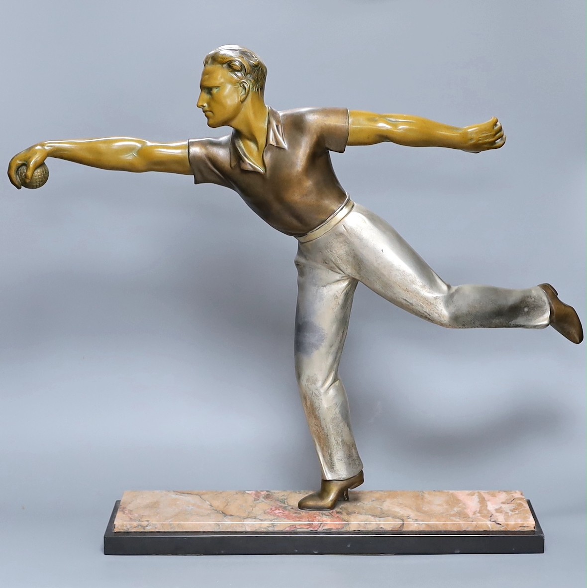 An Art Deco style bronzed and silvered spelter figure of a boule player, on marble plinth, height 51cm